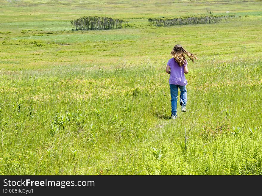 Young girl running in meadow. Young girl running in meadow