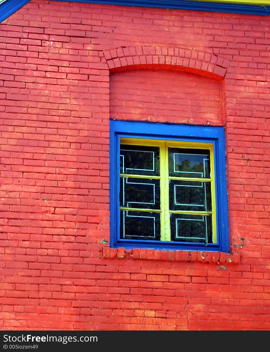 A colorful building and window create a nice graphic background. A colorful building and window create a nice graphic background.