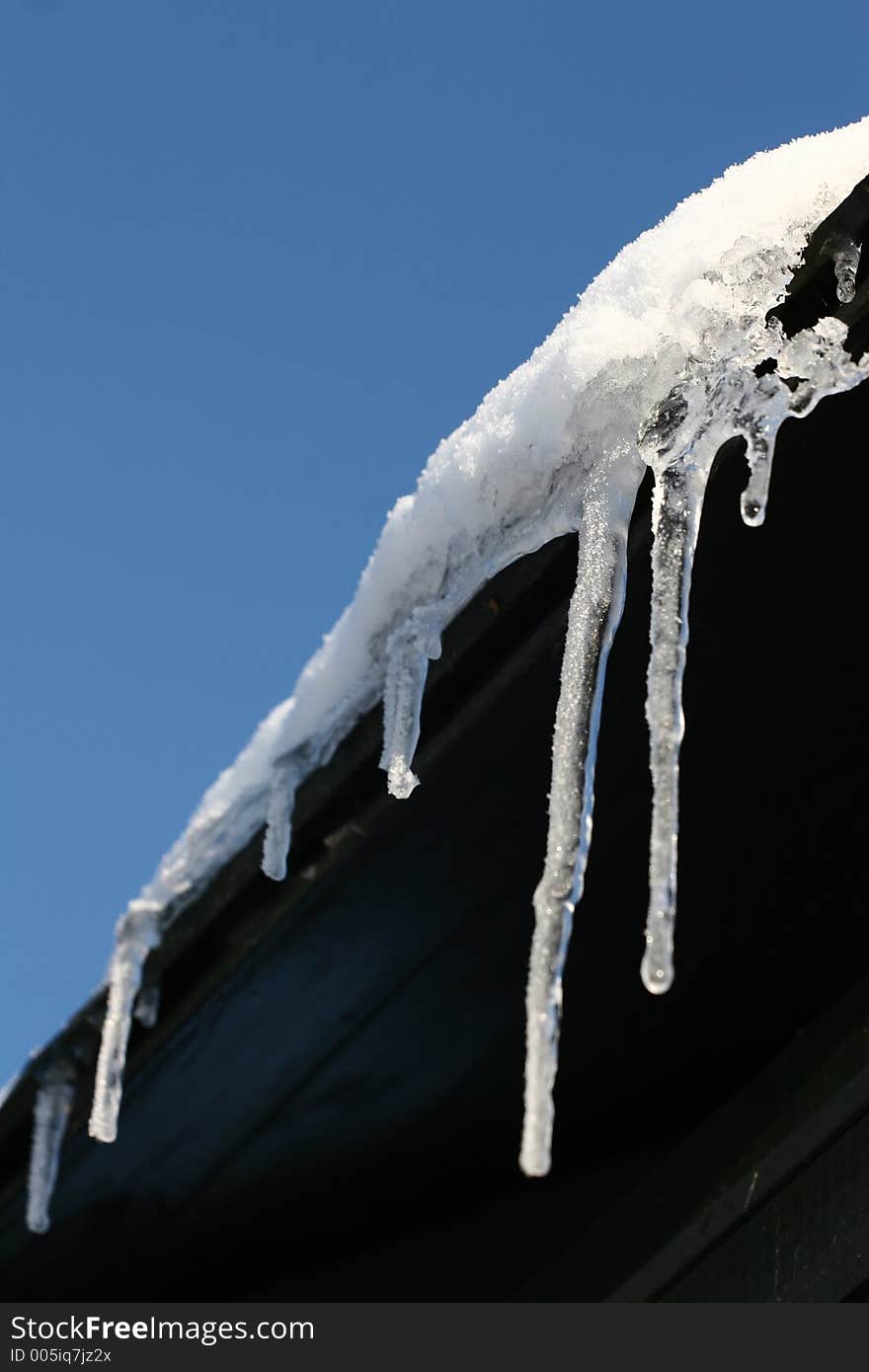 Ice - frozen water from a roof. Ice - frozen water from a roof