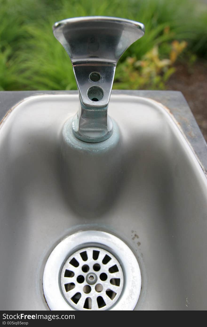 Outdoor drinking fountain and drain.