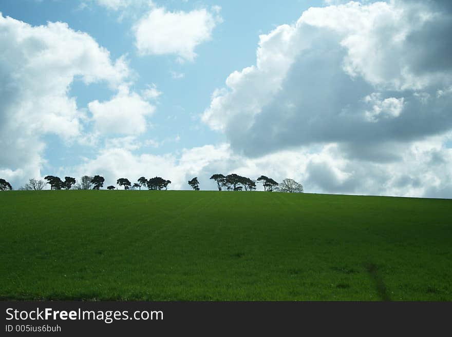 Clouds in blue sky over green hills. Clouds in blue sky over green hills