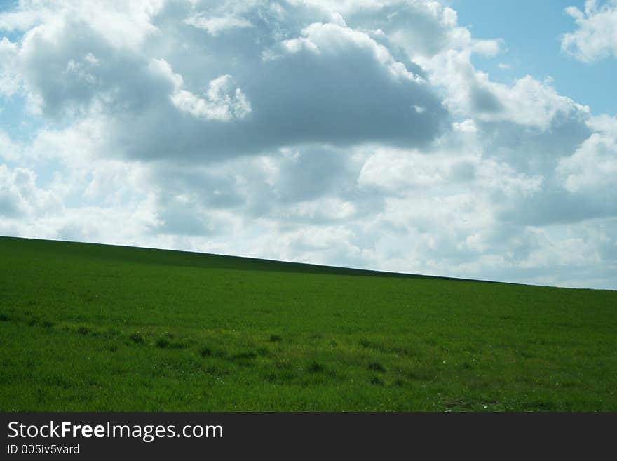 Clouds in blue sky over green hills. Clouds in blue sky over green hills