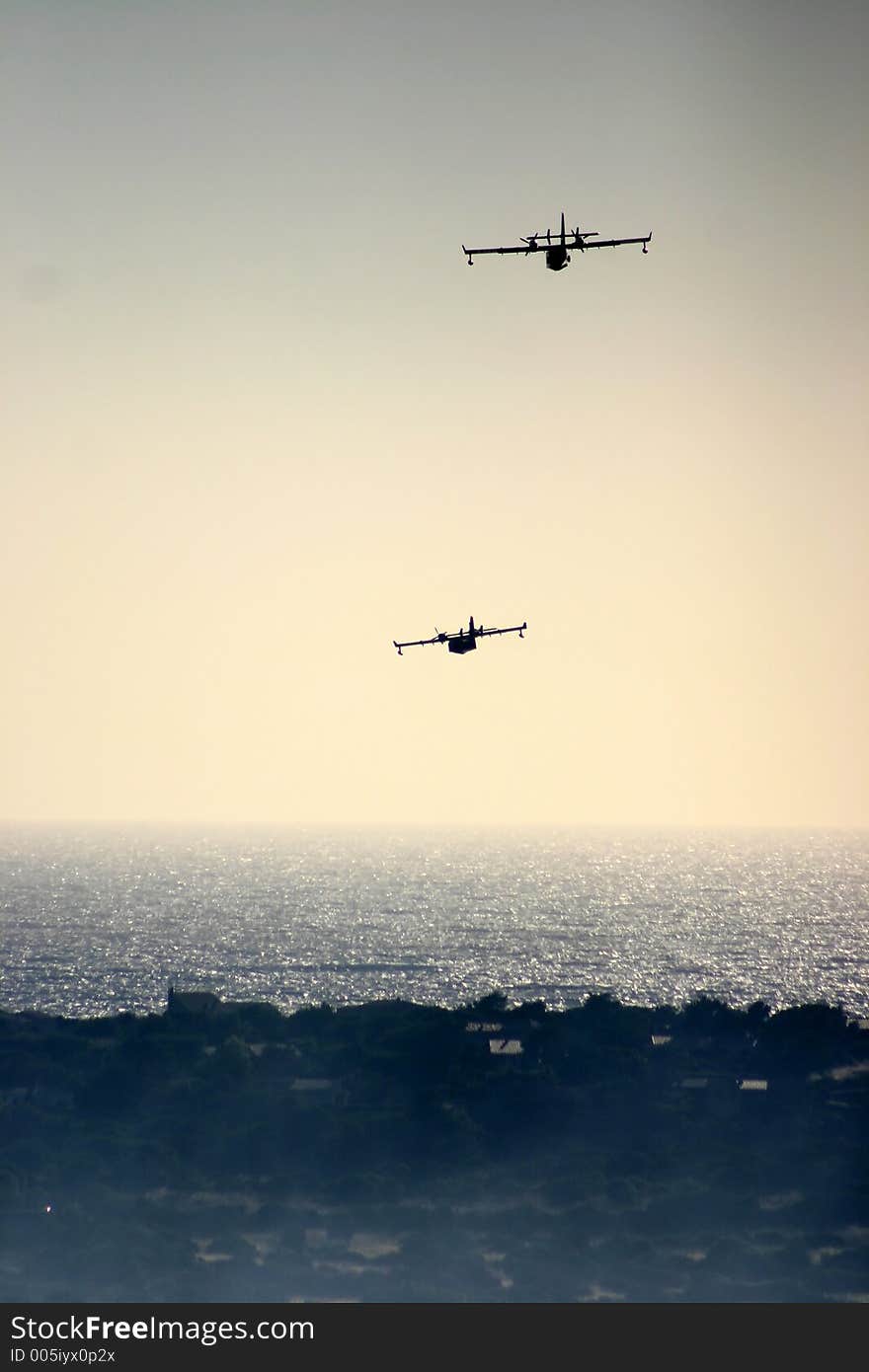 Fire in the corsican mountains: a plane is throwing water on the fire. Fire in the corsican mountains: a plane is throwing water on the fire