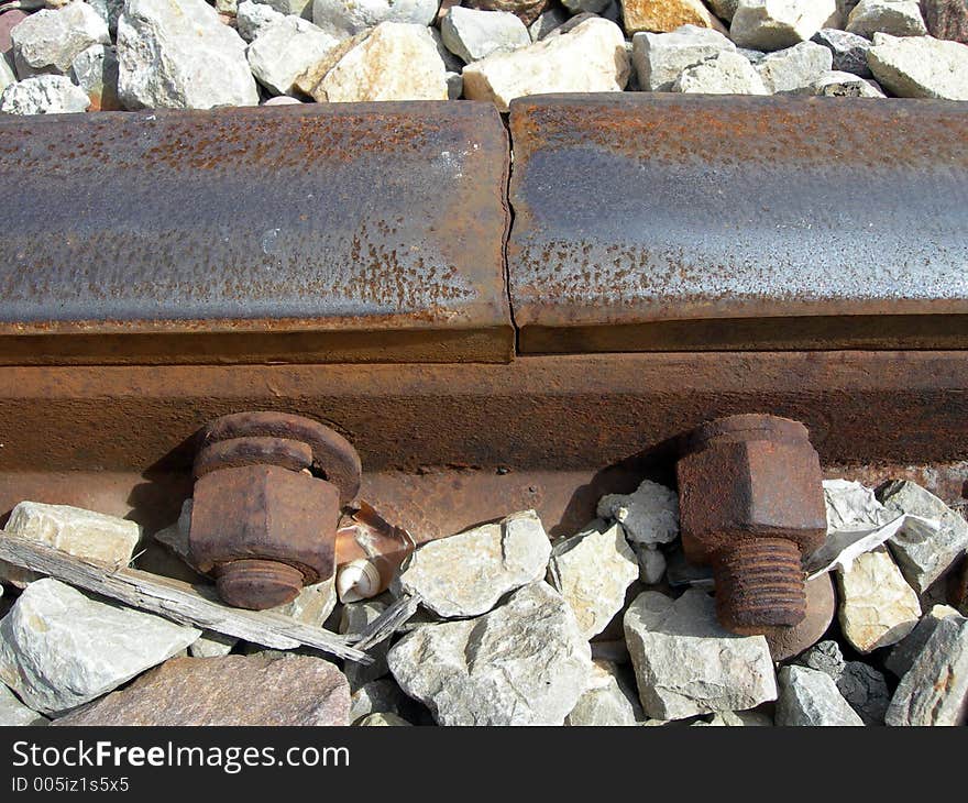 Oxidized union of train tracks with two screws