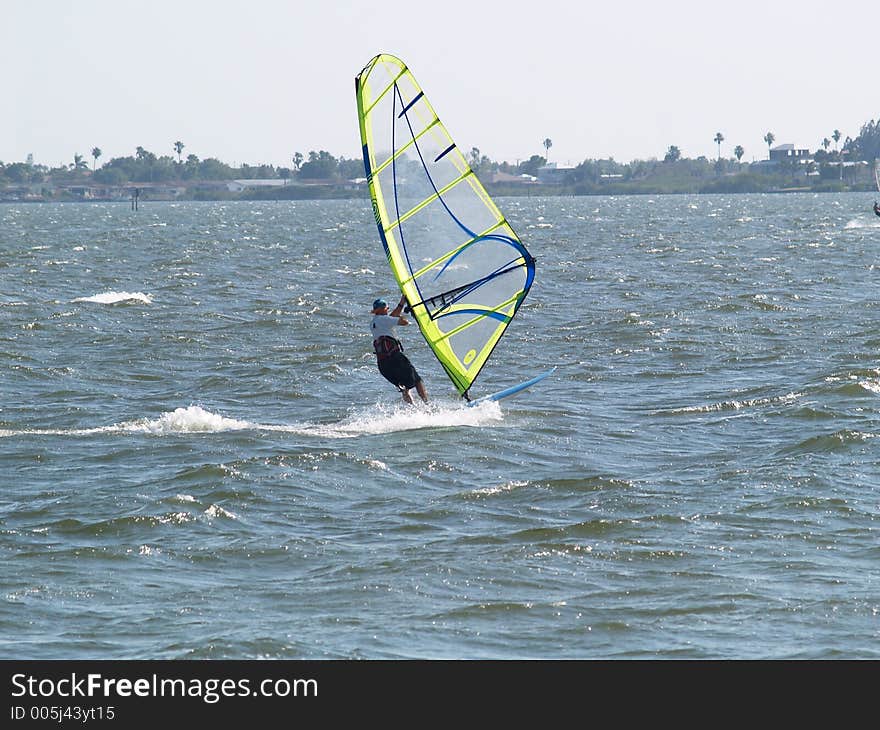 This wind surfer moves really fast accross the water propelled by the warm Florida winds in the Indian River near Port Canaveral, FL. This wind surfer moves really fast accross the water propelled by the warm Florida winds in the Indian River near Port Canaveral, FL.