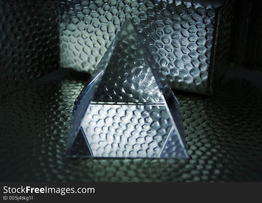 Pyramid of glass with metal background. Pyramid of glass with metal background