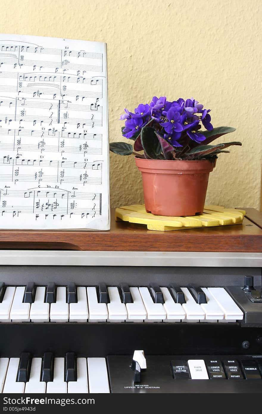 Piano, sheetmusic and violets. Piano, sheetmusic and violets