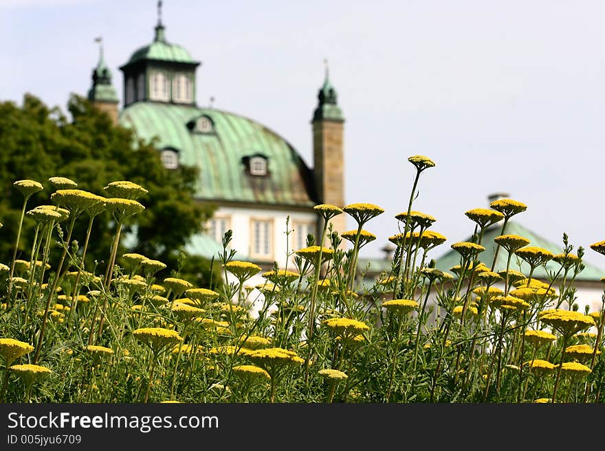 Castel of fredensborg in denmark a sunny summer day, with flowers in the foreground