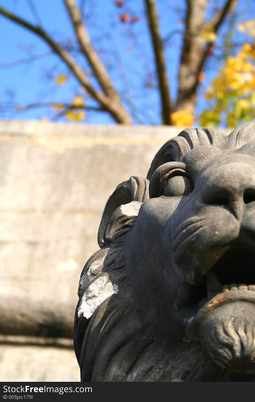 Lion statue in front of a blue sky.