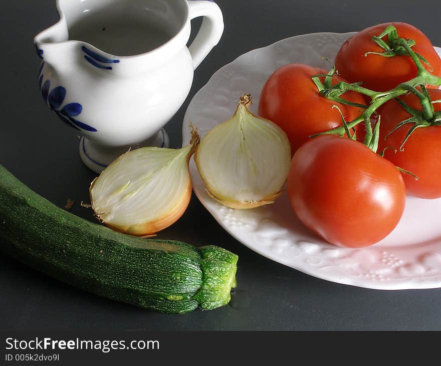 Tomato, onion and zucchini still life