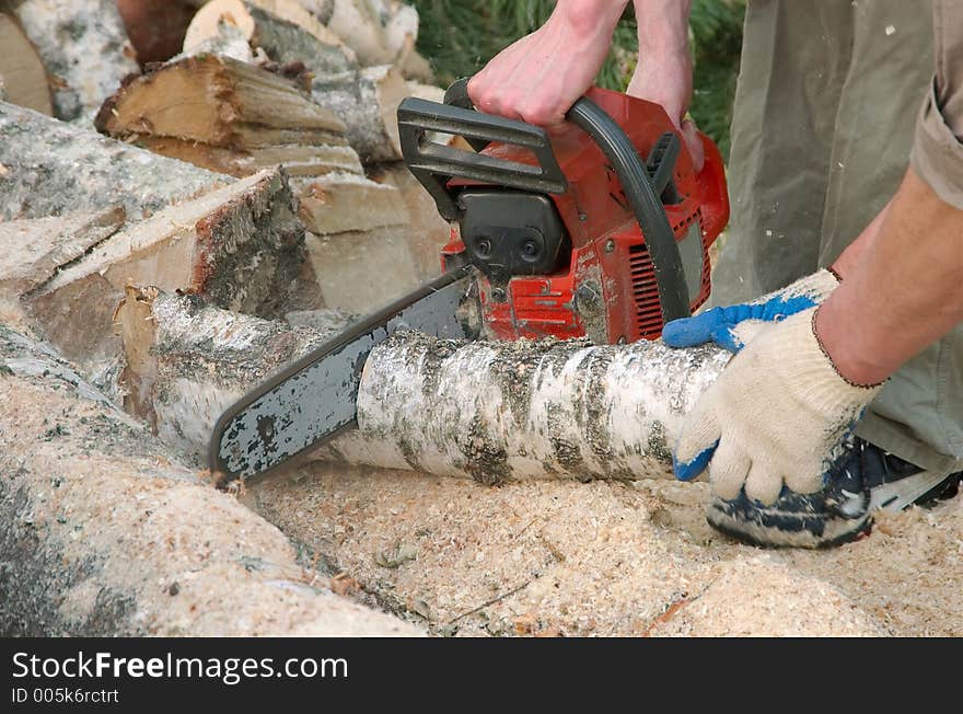 Cutting log with chainsaw