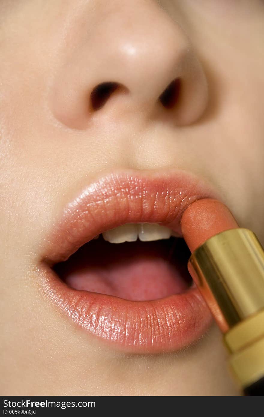 Nice girl applying lipstick. Nice girl applying lipstick