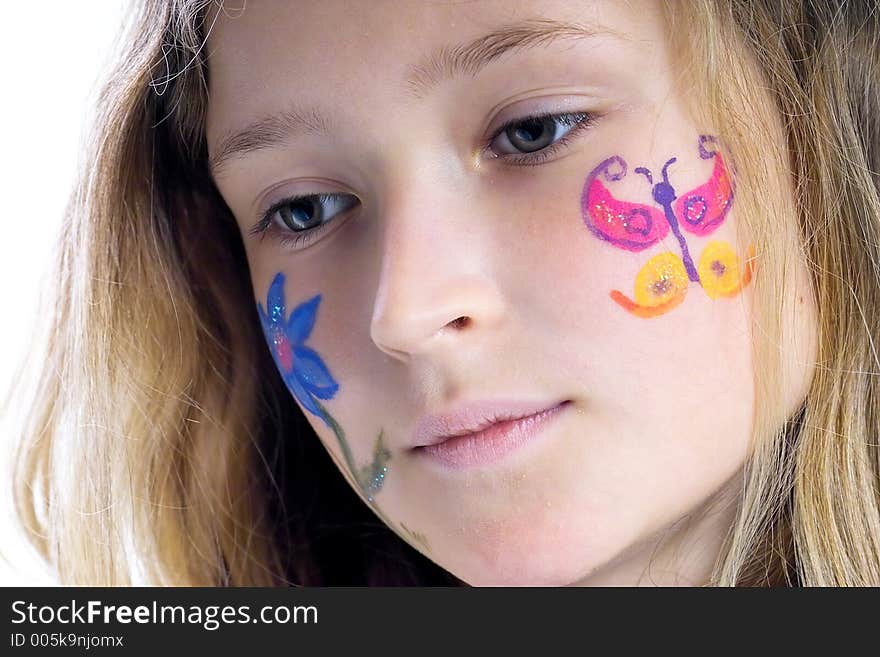 Beautiful young girl with a flower and butterfl drawing on her cheek. Beautiful young girl with a flower and butterfl drawing on her cheek
