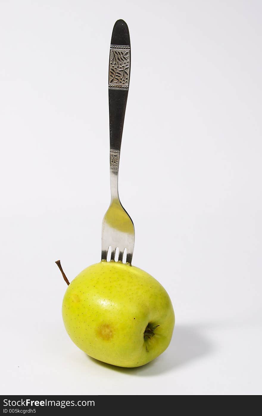 Green apple on a plug. Green apple on a plug.