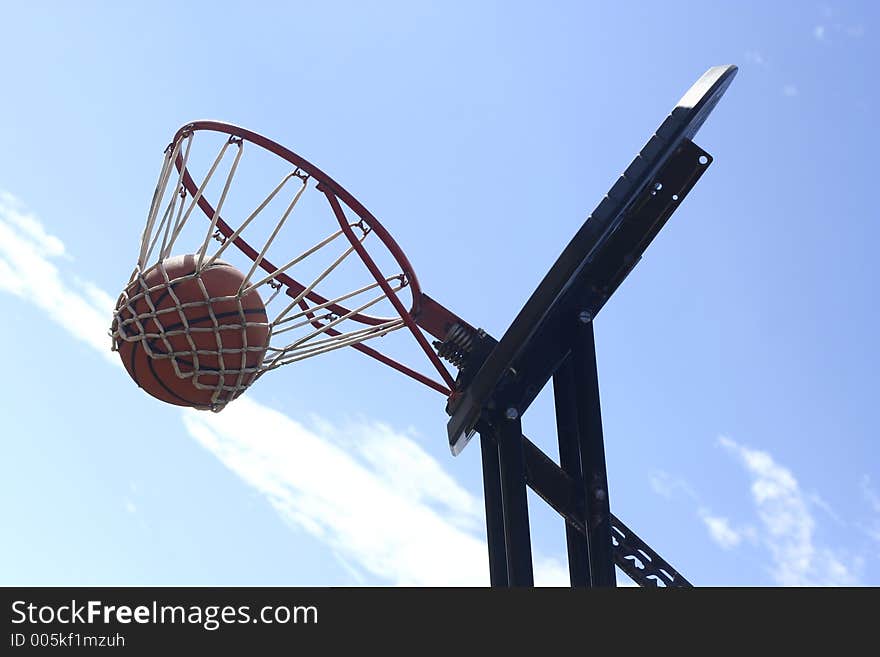 Basketball is suspended in net. Basketball is suspended in net