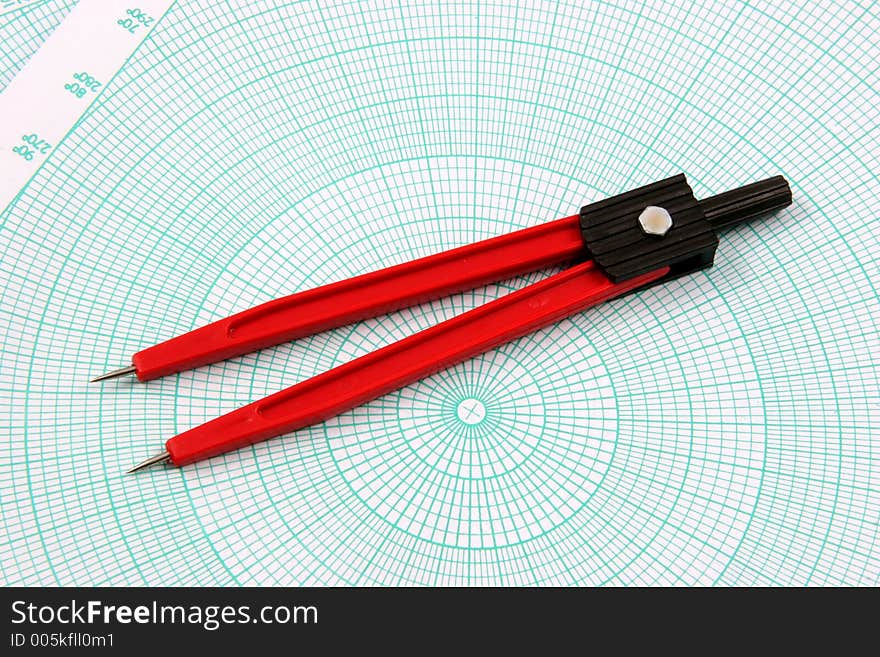 Red compass over a polar graphic paper. Red compass over a polar graphic paper