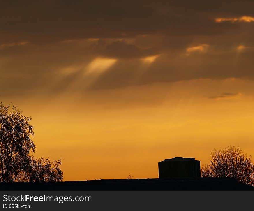 Sunrise over a farm and a tree