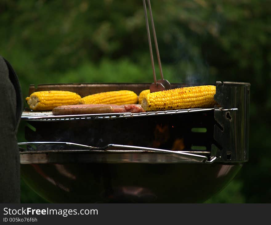 Nice filled barbeque with corn and sausages. Nice filled barbeque with corn and sausages