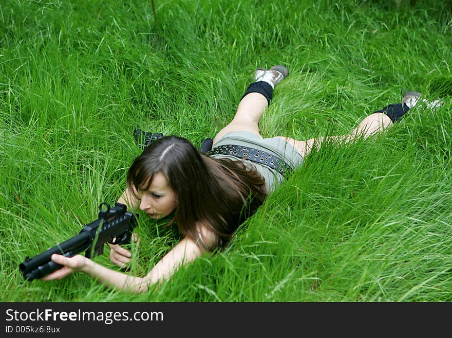 Girl aiming in grass