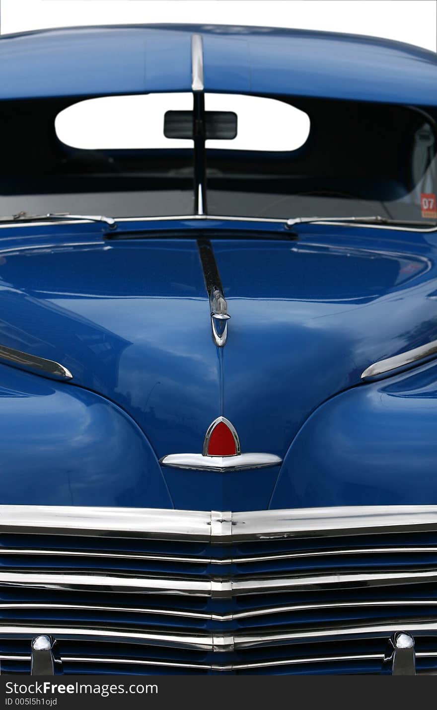 Photograph of the front end of an old classic car in mint condition, shining chrome and highly polished finish , absolutely beautiful, cropped shot isolated with clipping paths. Photograph of the front end of an old classic car in mint condition, shining chrome and highly polished finish , absolutely beautiful, cropped shot isolated with clipping paths