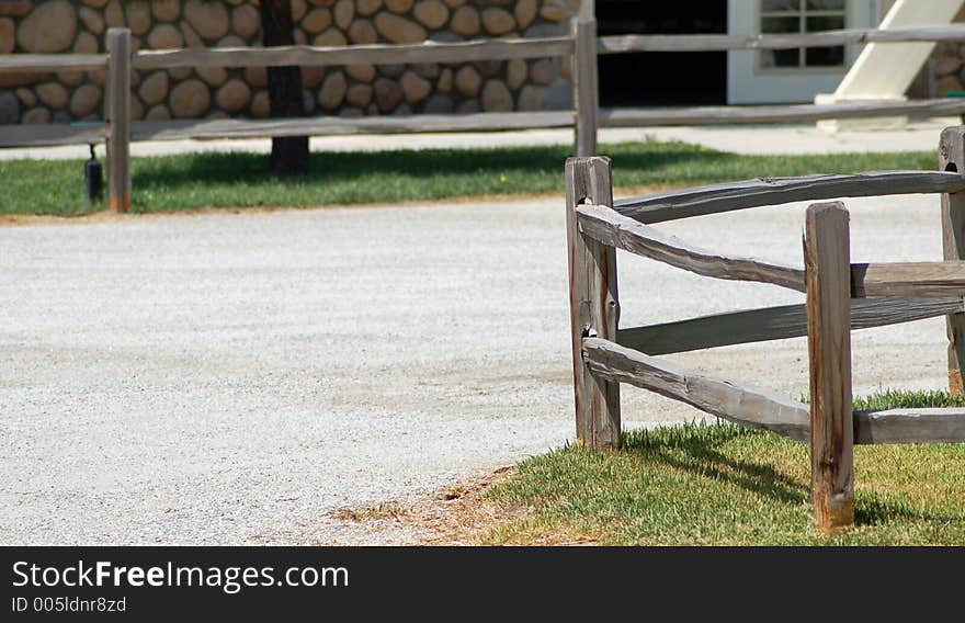 Wooden fence next to a dirt road