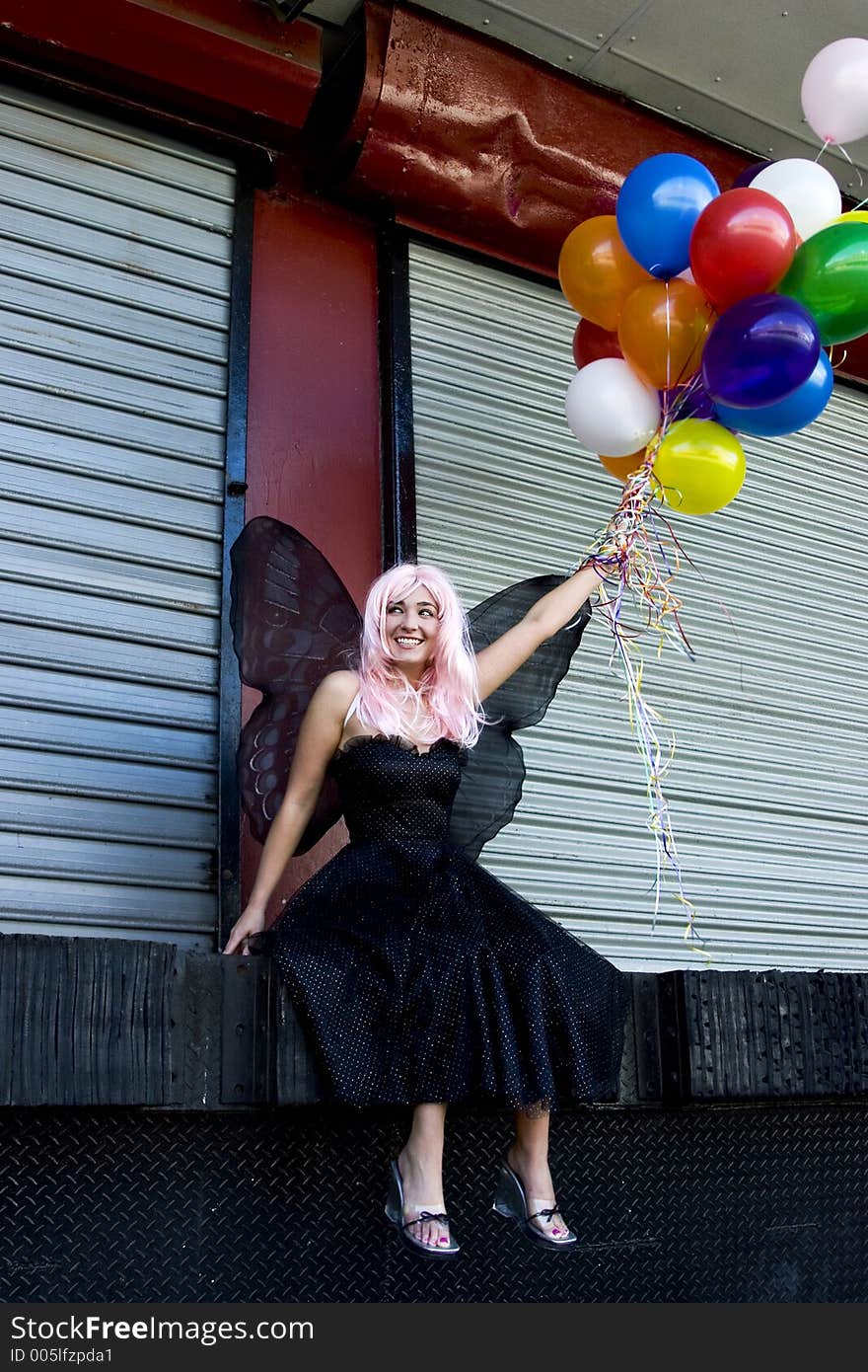 Fairy with balloons in an urban setting