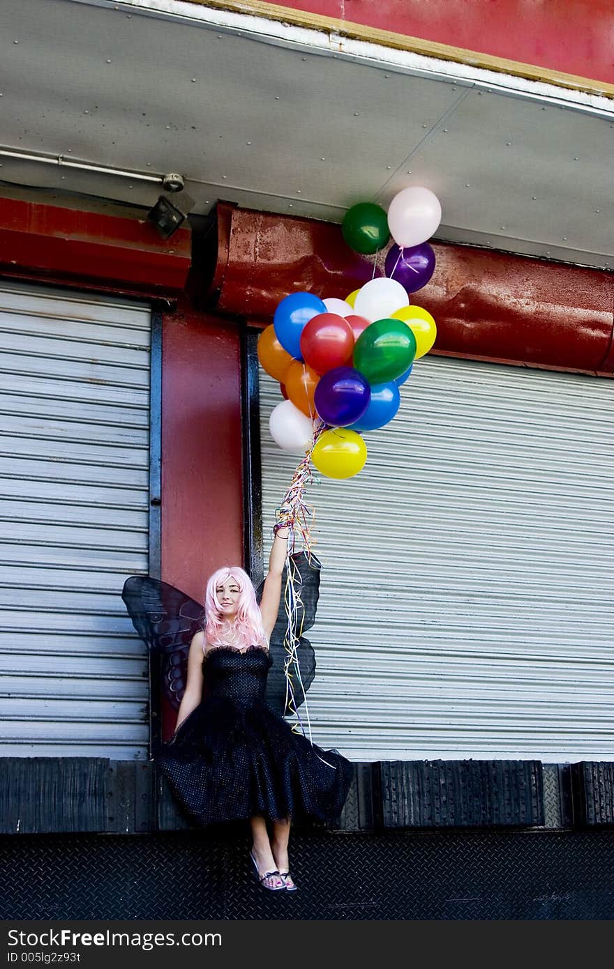 Fairy with balloons in an urban setting