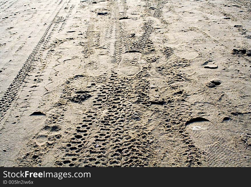 Tyre and foot prints in the sand. Tyre and foot prints in the sand