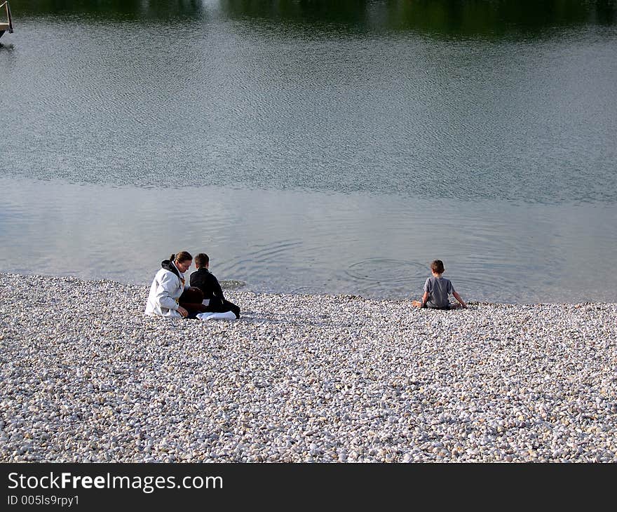 Mother and two young sons at lake. Mother and two young sons at lake