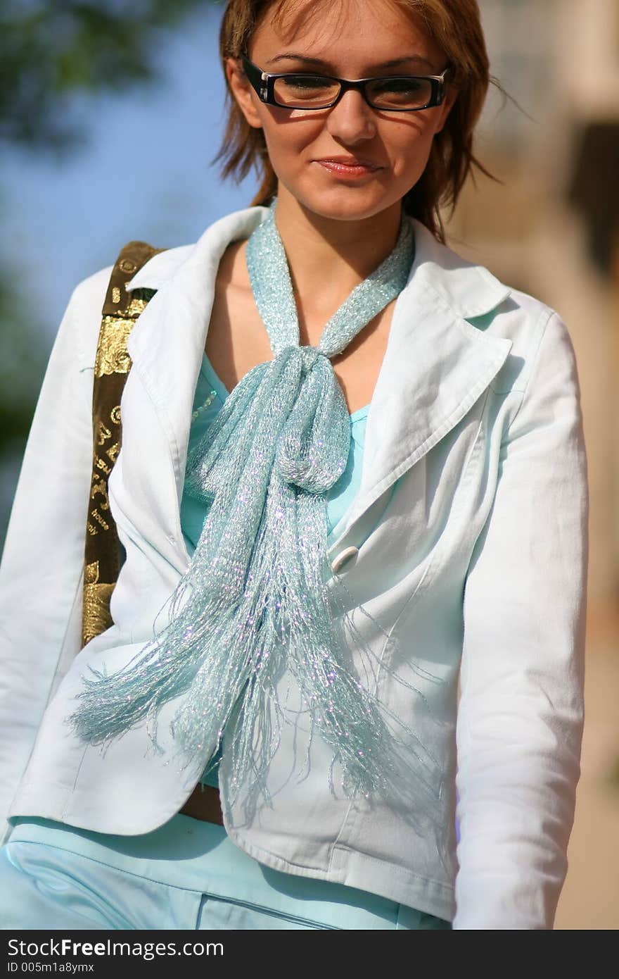 A young woman dressed with modern clothes walking on the street speedy. A young woman dressed with modern clothes walking on the street speedy