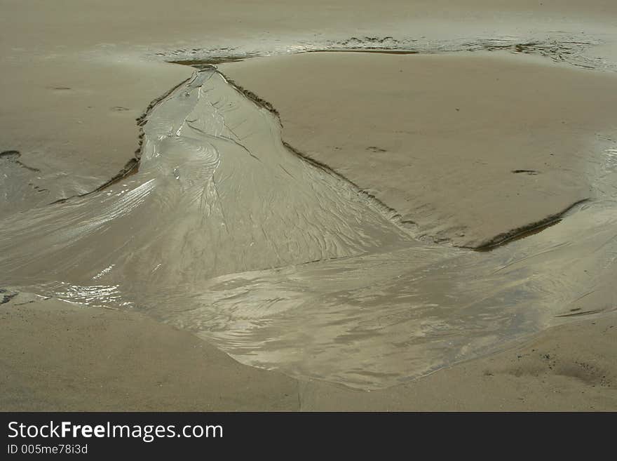 Tide water eroding sand; Oregon beach. Tide water eroding sand; Oregon beach