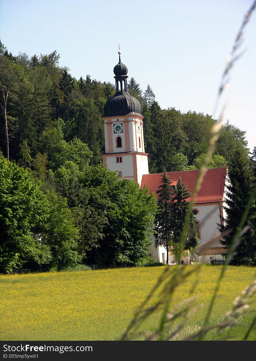 There is a chapel who is between the trees. There is a chapel who is between the trees