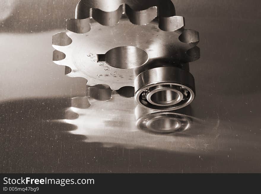 Gears and ball-bearing concept in sepia-toning against titanium. Gears and ball-bearing concept in sepia-toning against titanium