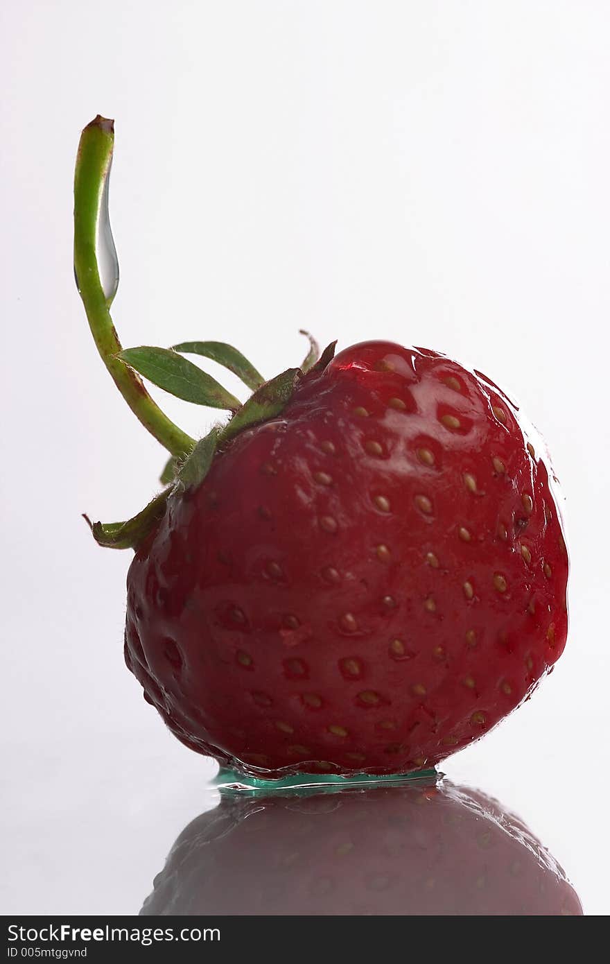 Beauty lonely red strawberry with reflex on the white background. Beauty lonely red strawberry with reflex on the white background