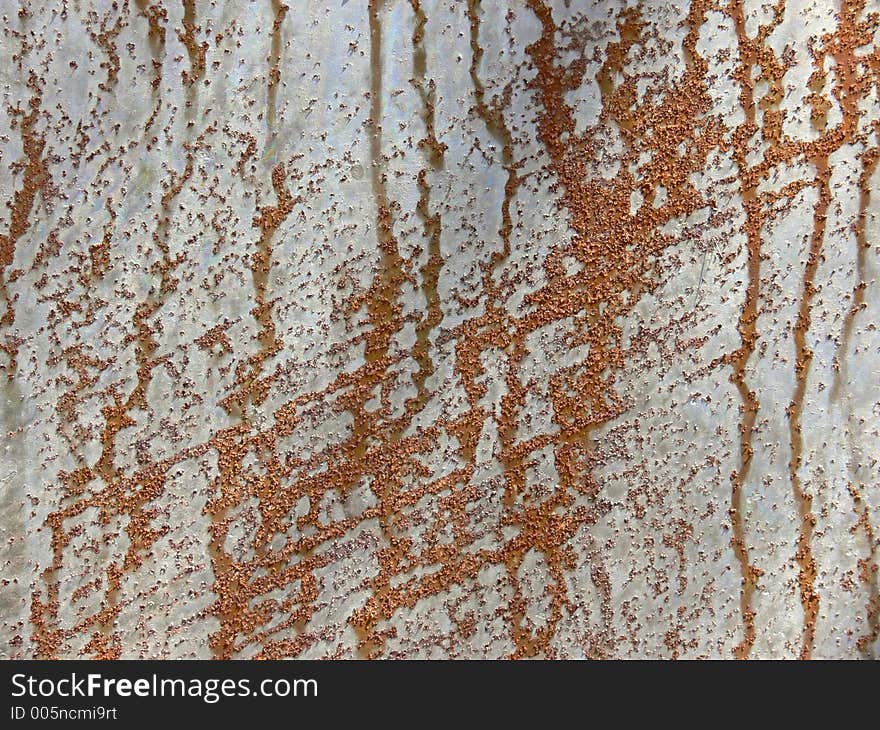 Pattern of rust on a metal plate. Pattern of rust on a metal plate.