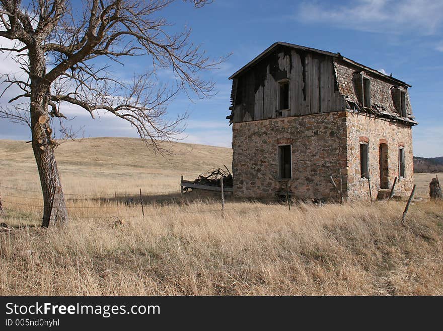 Abandoned house in a dry field of grass. Abandoned house in a dry field of grass