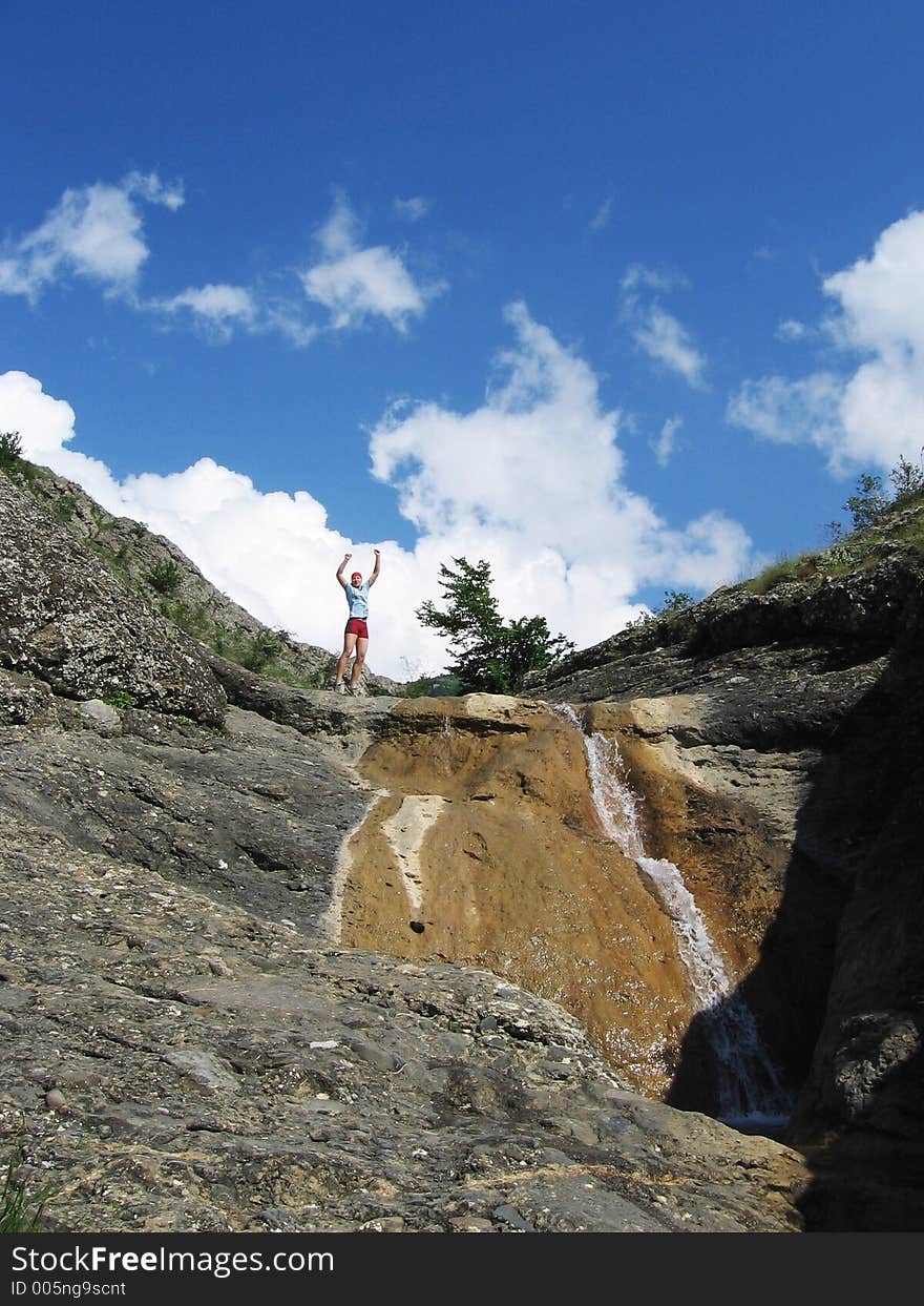 Jumping girl and waterfall