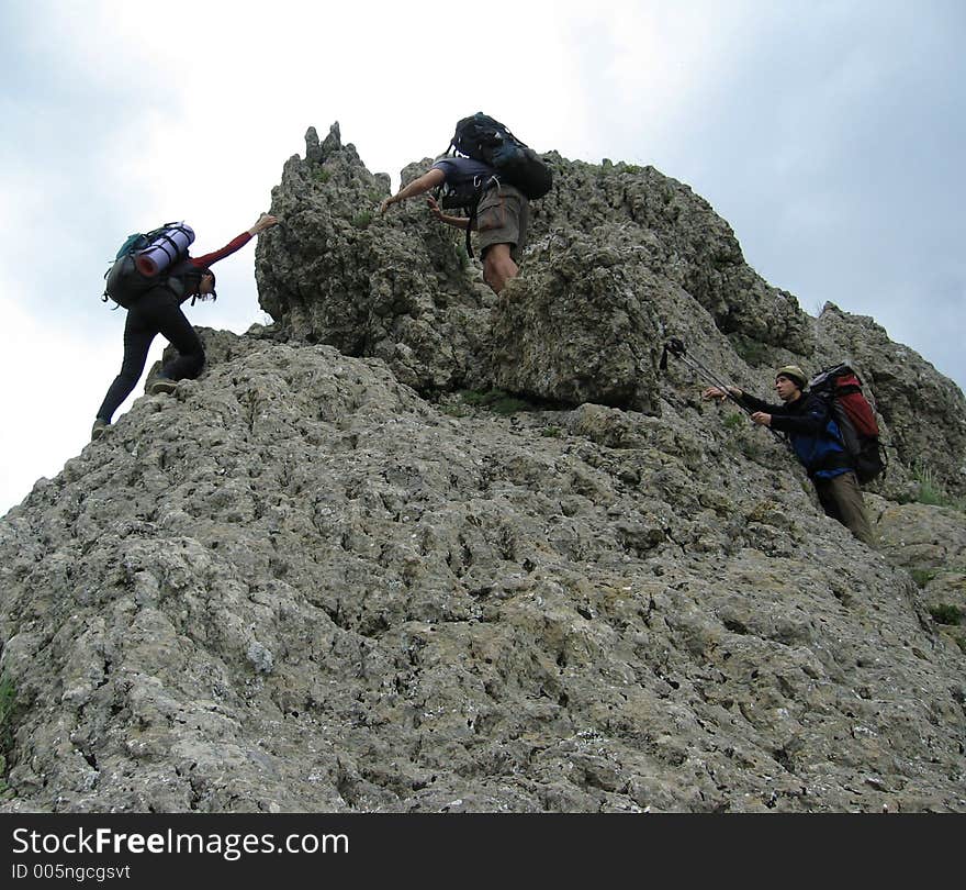 Three climbers in rock