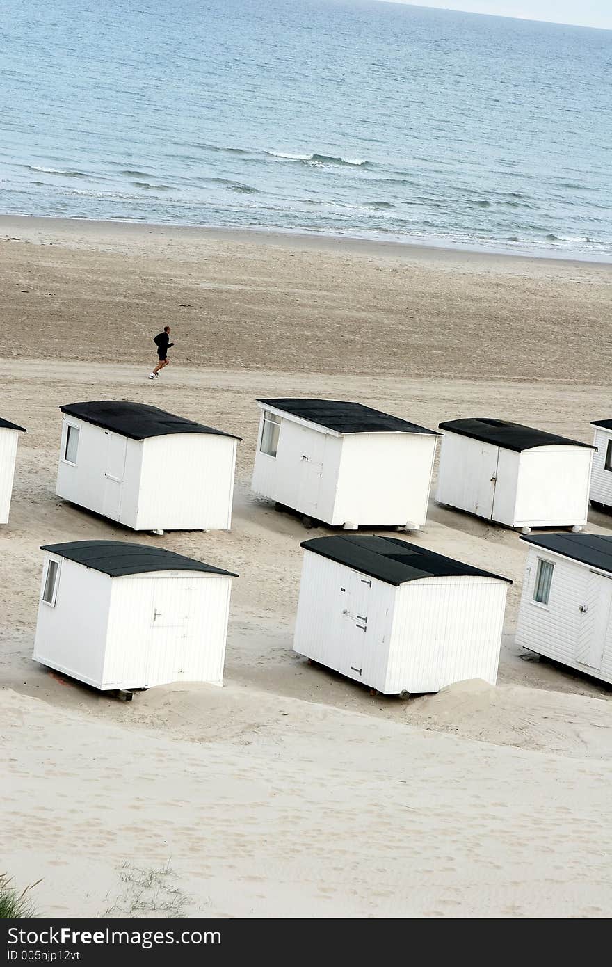 Summer in denmark:beach houses and man running. Summer in denmark:beach houses and man running