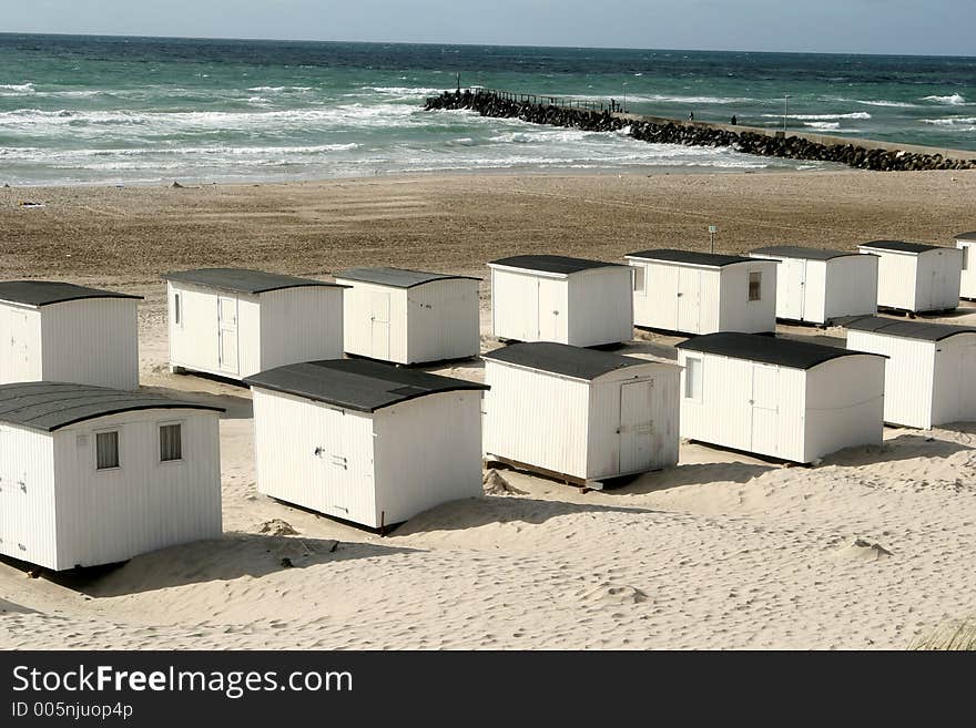 Summer in denmark:beach of loekken, beach houses in line