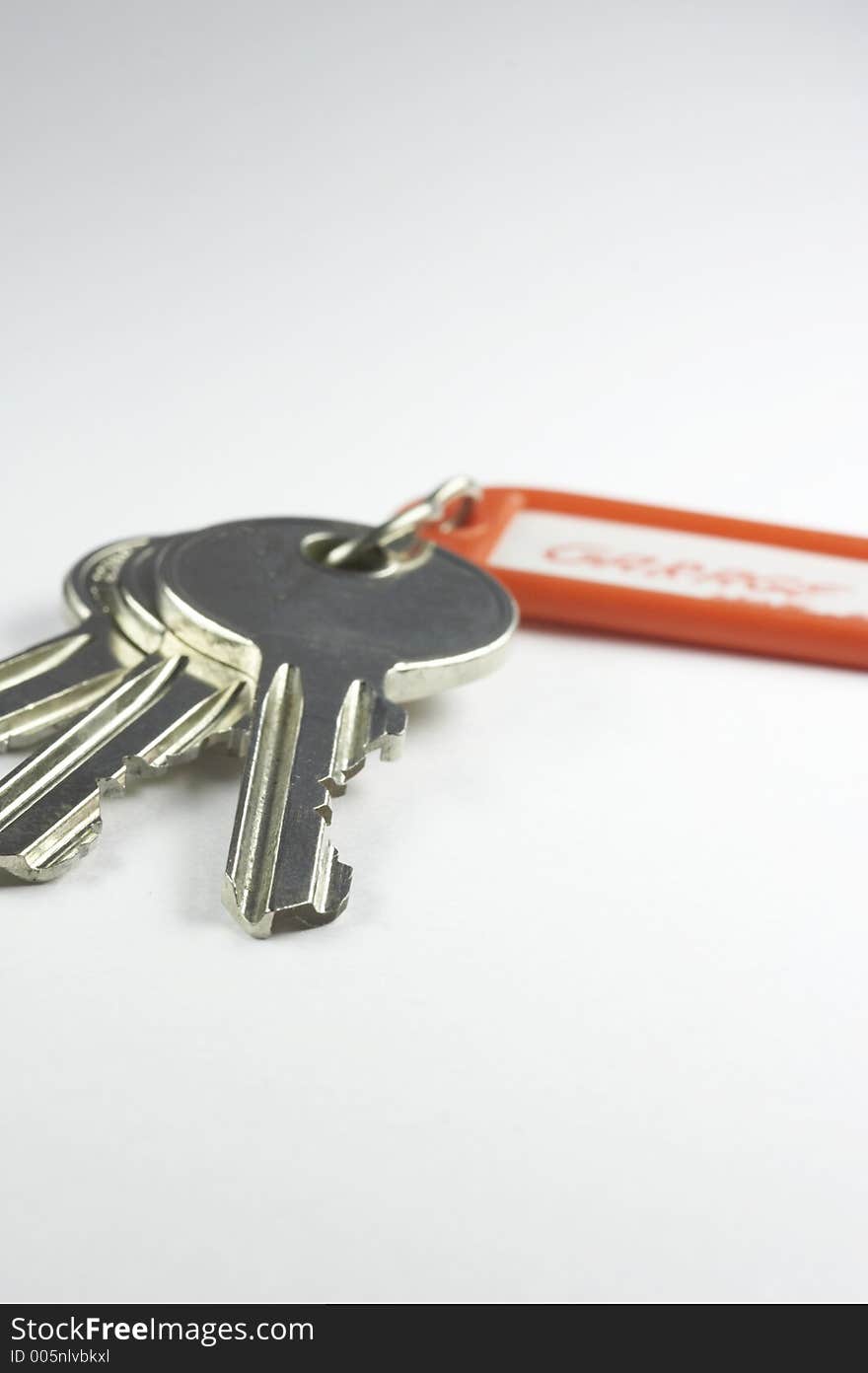 Keys with a red key fob on white background. Keys with a red key fob on white background