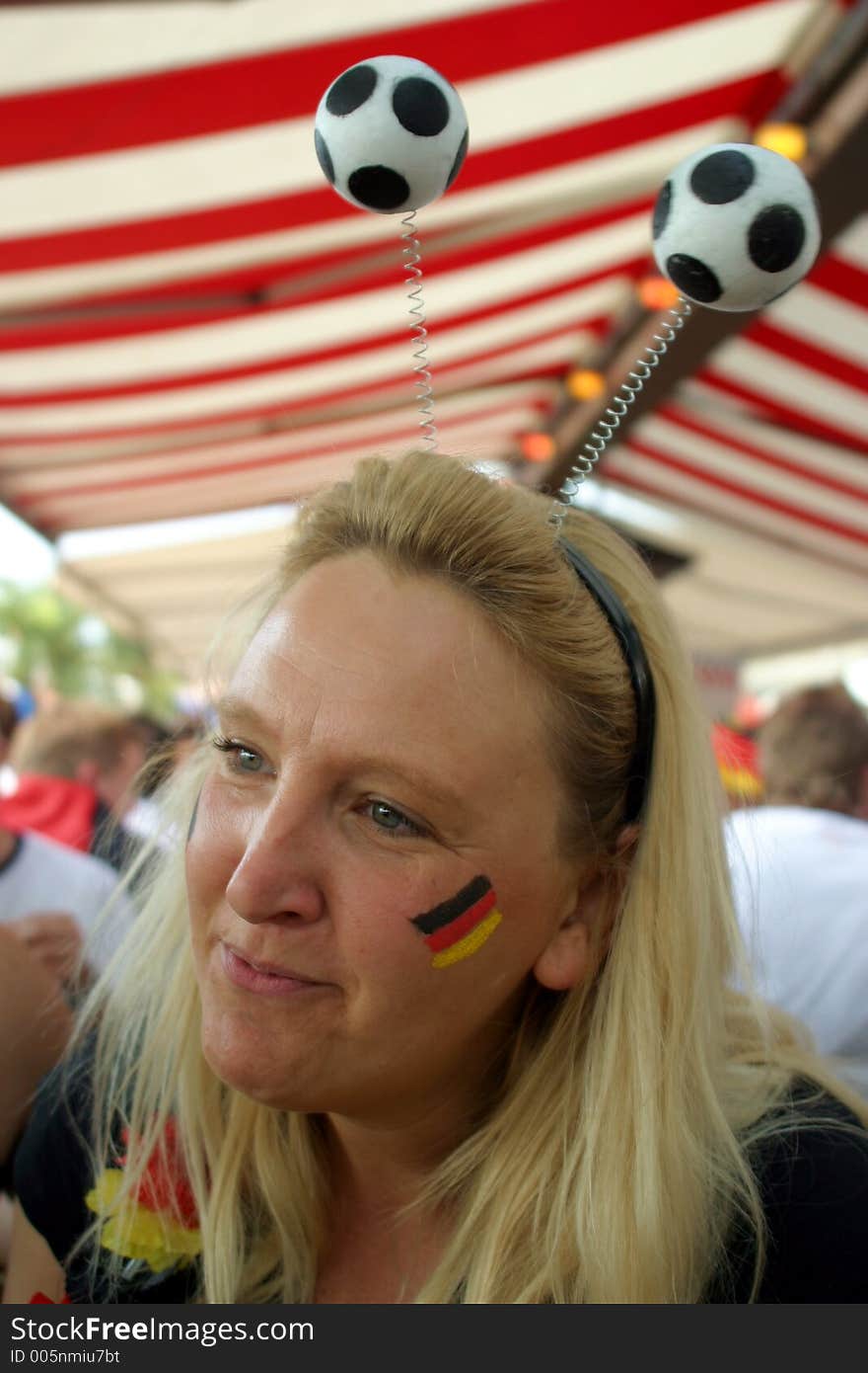 Blond soccer girl at a live broadcast in an outdoor bar