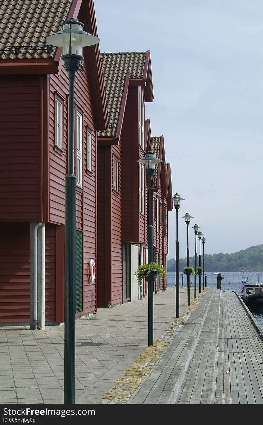 Traditional style, wooden shophouses on the quay in Farsund on the south coast of Norway. Traditional style, wooden shophouses on the quay in Farsund on the south coast of Norway