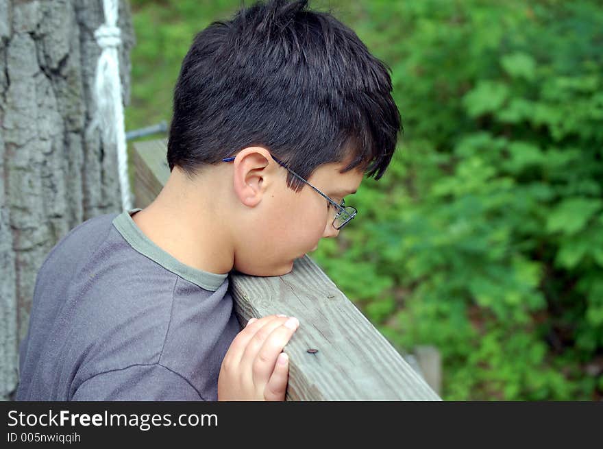 Boy looking over bridge. Boy looking over bridge