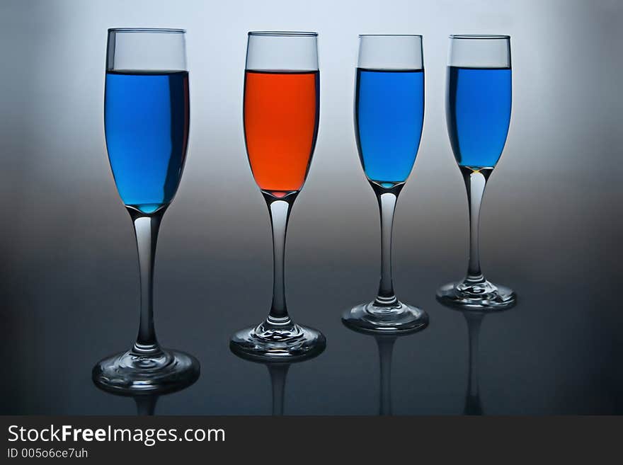 Wineglasses filled with colored liquid - illustrating concepts such as Workplace Diversity, Dare to be Different, or Democrat vs Republican. Wineglasses filled with colored liquid - illustrating concepts such as Workplace Diversity, Dare to be Different, or Democrat vs Republican.