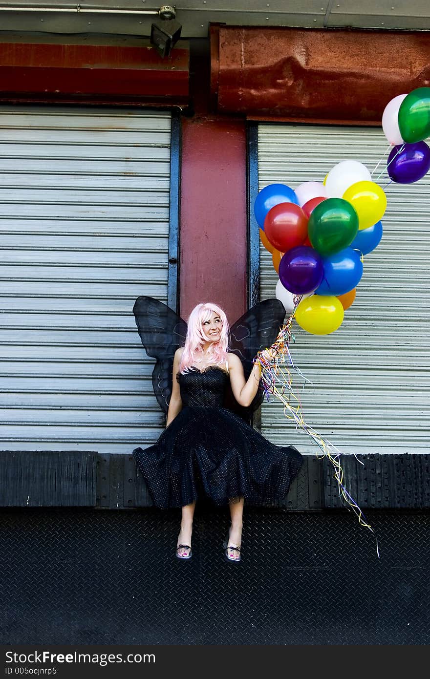 Fairy with balloons in an urban setting