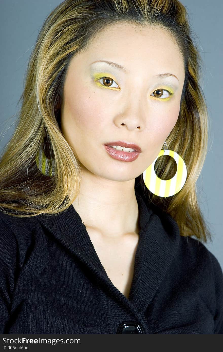 Headshot of a Japanese woman wearing earrings