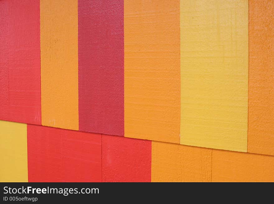 Painted wood background in red, yellow and orange colors. Painted wood background in red, yellow and orange colors