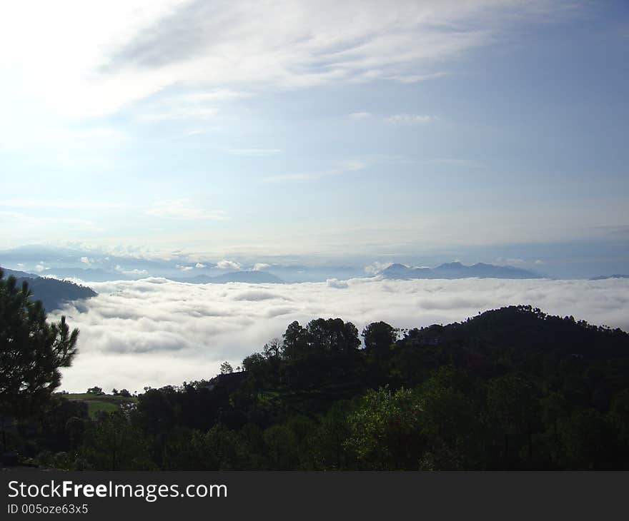 A Calm and serene view of mountain and clouds. A Calm and serene view of mountain and clouds