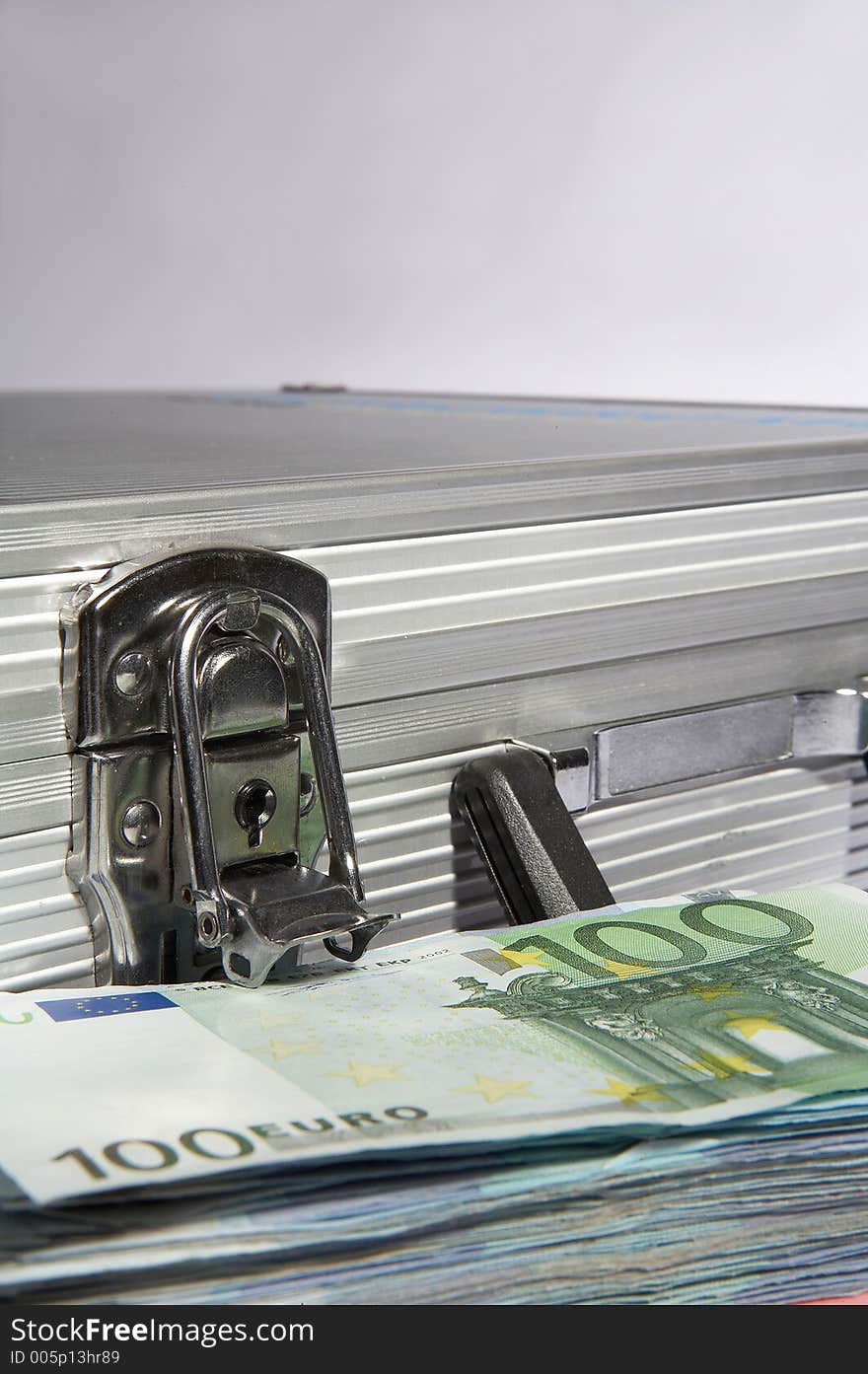 Aluminium suitcase with a pile of european papermoney. Aluminium suitcase with a pile of european papermoney